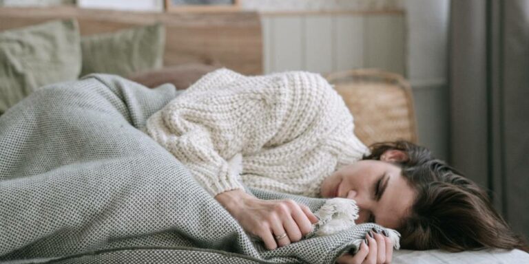 sad woman in pain wearing white